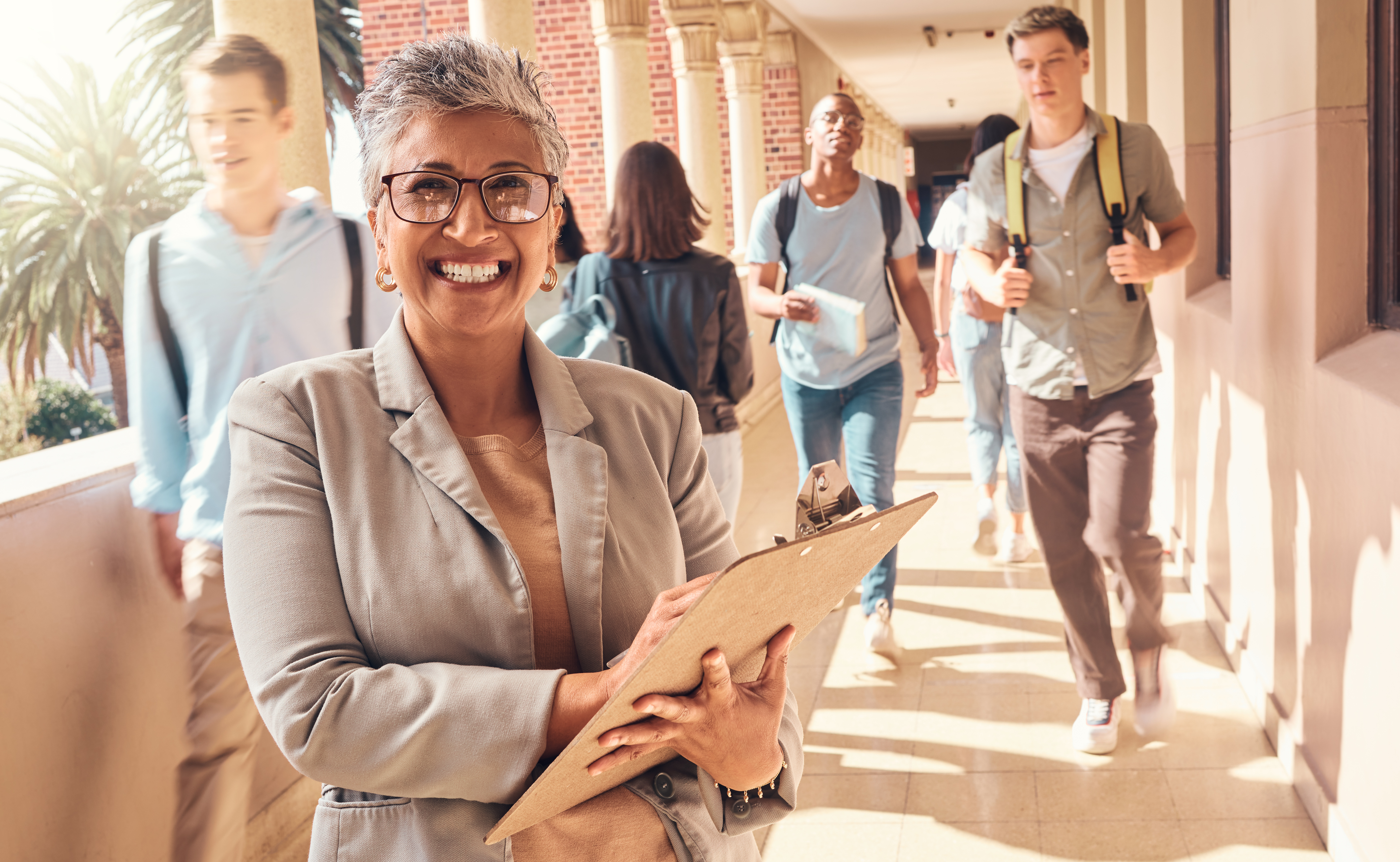 Education clipboard, students and portrait of teacher happy on college campus for coaching, teaching and learning. Knowledge study, high school principal or university professor with daily checklist.